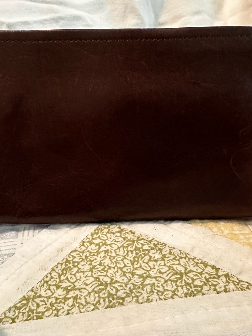 Large Hobo brand chocolate brown zippered wallet with two compartments.